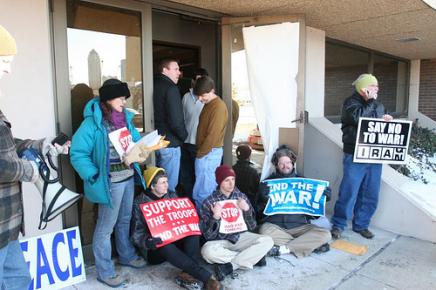 Three Hillary Clinton campaign staff guard the entrance to her Des Moines, Iowa headquarters as peace activists conduct a sit-in to protest the candidate's support for the war in Iraq. (Photo: Mauro Heck )