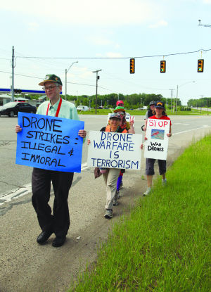 Phil Runkel, left, of Waukesha, Wis., is part of a group walking to protest the use of drones in warfare.: photo by Kristy Noack