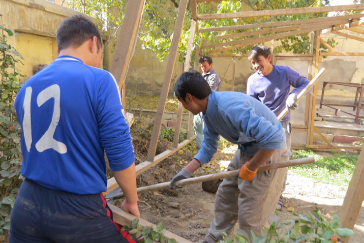 Ghulam ( second from left ) working on our community’s greenhouse, together with Zek, Khamad and Ali